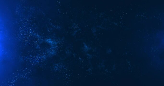 A vortex of blue particles slowly unfolding against a blue background. Bokeh particles. Water vapor in blue light.