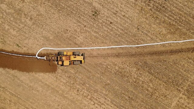 The pipe laying machine digs the ground and lays the pipe in the field. Creation of a drainage system.