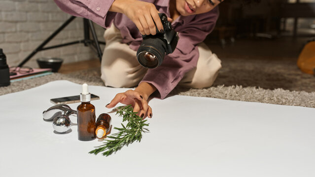 Girl making photo of massager, oil and branch