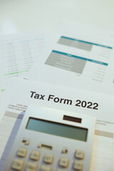 tax form 2022 and calculator at desk