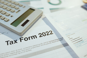 tax form 2022 and calculator at desk