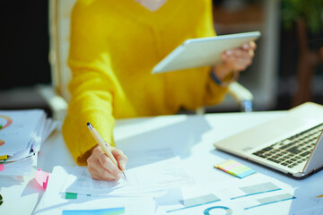 Business owner woman using tablet PC and working with documents