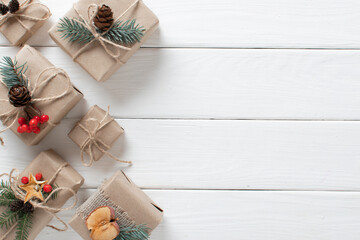 Christmas gifts wrapped in kraft paper with various organic decorations orange