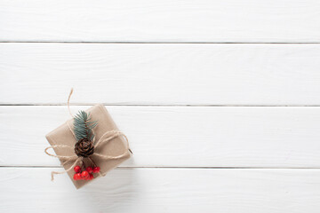 A Christmas gift wrapped in kraft paper with various organic decorations. Zero waste. Do it yourself.