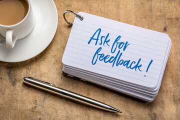 Ask for feedback - reminder on a stack of  index cards with a cup of coffee, business communication concept