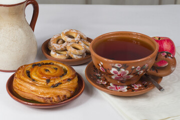 a cup of tea with a breakfast bun