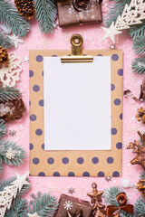 Blank paper on tablet with frame made frome pine tree branches and Christmas decoration in snow top...
