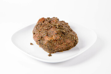 Raw pork loin seasoned - ready to be roasted, on a plate