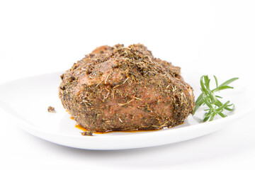 Raw pork loin seasoned - ready to be roasted, on a plate