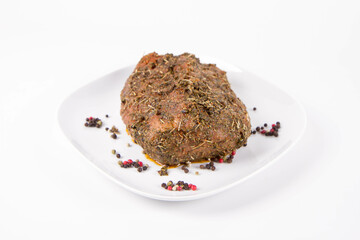 Raw pork loin seasoned - ready to be roasted, on a plate