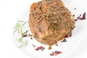 Raw pork loin seasoned - ready to be roasted, on a plate