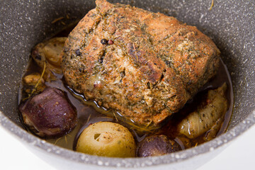 Roast pork loin with onions and garlic, in a pot