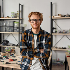 IT technician with crossed arms looking at camera