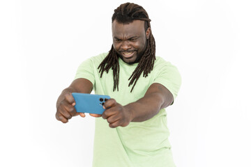 Confused African American man looking at mobile phone screen. Serious man having online video call with friend or having some problems with gadget. Communication, technology emotion concept