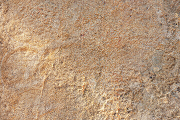 Stone wall is sand colored with real orange spots and patterns. Textured background is made of sand-colored stone.
