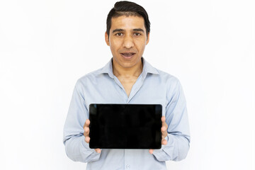 Surprised man holding tablet. Indian man in blue shirt showing tablet screen. Portrait, studio shot, technology, advertising concept