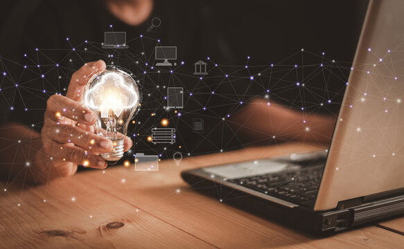 Business global internet connection application technology and digital marketing, Businessman holding light bulb with clouds internet connection. Financial and banking, Digital link tech, big data.