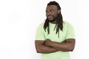 Fototapeta premium African American man with folded arms looking at copyspace. Handsome man in T-shirt promoting product while standing on white background. Advertising, promotion concept