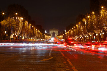 The Triumphal Arch and Champs Elysees avenue illuminated for Christmas at night ,Paris, France.