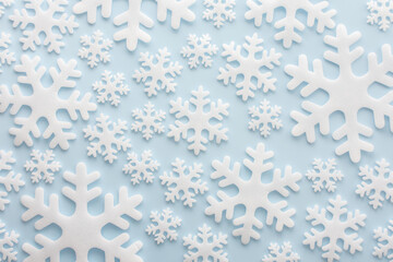 White snowflakes on a blue background, Christmas background, Merry Christmas and Happy New Year concept, top view