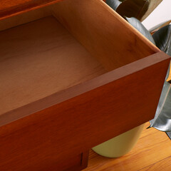 Mid-Century Modern 5 Drawer Chest. Vintage wooden walnut set of drawers. Detail photograph of an heirloom furniture piece. Better Goods