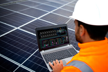 Solar panels installation for sustainable energy. Electrical engineer holding laptop computer with solar panels scheme and checking productivity.