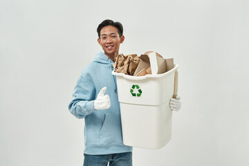 Asian man with thumb up hold bin with cardboard