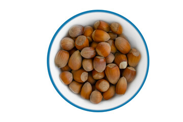 Hazelnuts in a plate on a white background