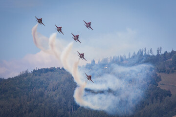 Close formation of several jet fighters from the swiss Patrouille Suisse military aerobatic team