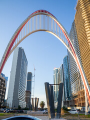 Many windows. Arch at the entrance. Tall buildings. Modern apartment building. City center.  Architectural ensemble