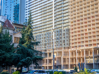 Many windows. Arch at the entrance. Tall buildings. Modern apartment building. City center. ...