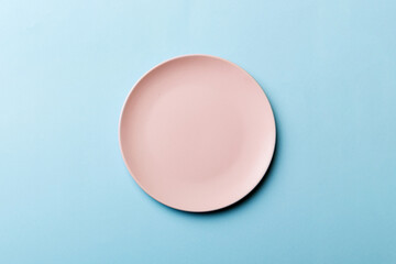 Fototapeta na wymiar Top view of isolated of colored background empty round pink plate for food. Empty dish with space for your design