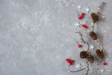 Gray winter christmas background with larch branches, cones, red viburnum berries, snowflakes....