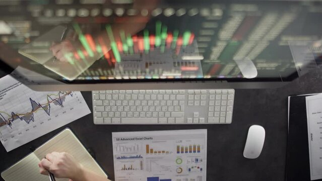 Close-up of working month in office with pc graphs on paper keyboard and phone. A businessman works at a computer. High quality 4k footage