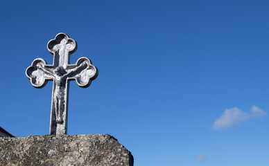 Stone cross against beautiful sunset copy space concept belief.Religion easter