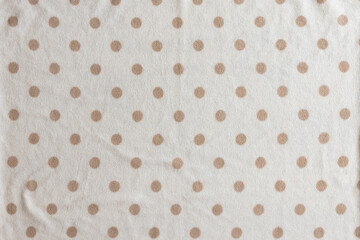 dark brown blanket background with dark dots
