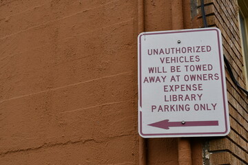 library sign informs of parking violation penalties