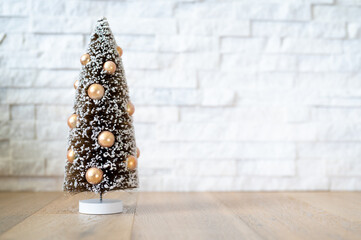 Christmas tree ornament on a white stone background with copyspace.