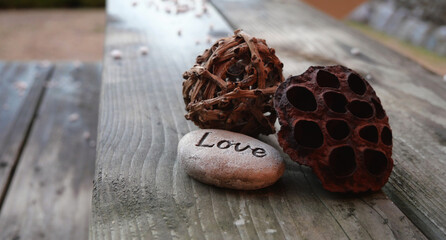 Love inspiration written on a decorative pebble	