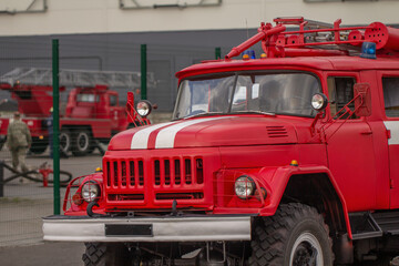 An old fire truck and a fire brigade of rescuers.