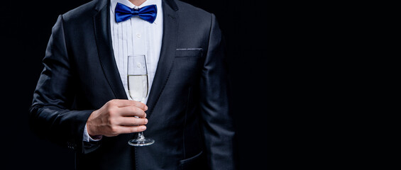 cropped view of tuxedo man cheering in studio. tuxedo man cheering with champagne.