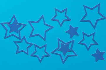 blue paper stars on a blue paper background
