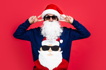 bearded santa man in hat and glasses smiling while prepare for celebrating happy new year party and...