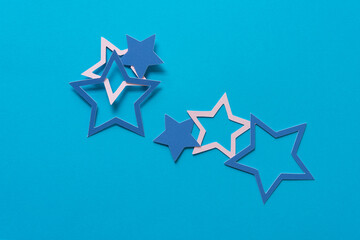 several paper stars on a blue background
