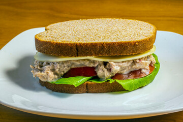 tuna fish sandwich  top with provolone cheese,  cheese