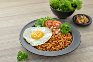 Indomie goreng Indonesian Popular Instant fried Noodle. Served with Sunny Side Egg, Tomato, Cucumber, letucce, and chilli. Highly favourite for housewives eaten at me time.
