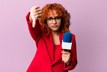 red hair pretty woman feeling cross,showing thumbs down. journalist and presenter concept