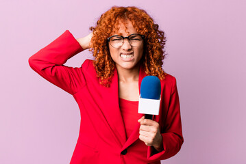 red hair pretty woman feeling stressed, anxious or scared, with hands on head. journalist and...