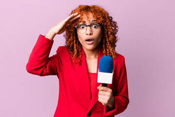 red hair pretty woman looking happy, astonished and surprised. journalist and presenter concept