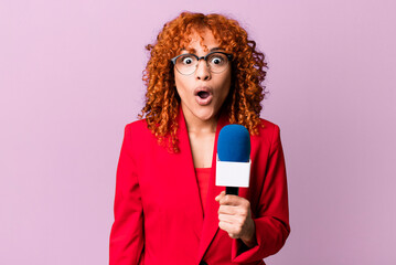 red hair pretty woman looking very shocked or surprised. journalist and presenter concept